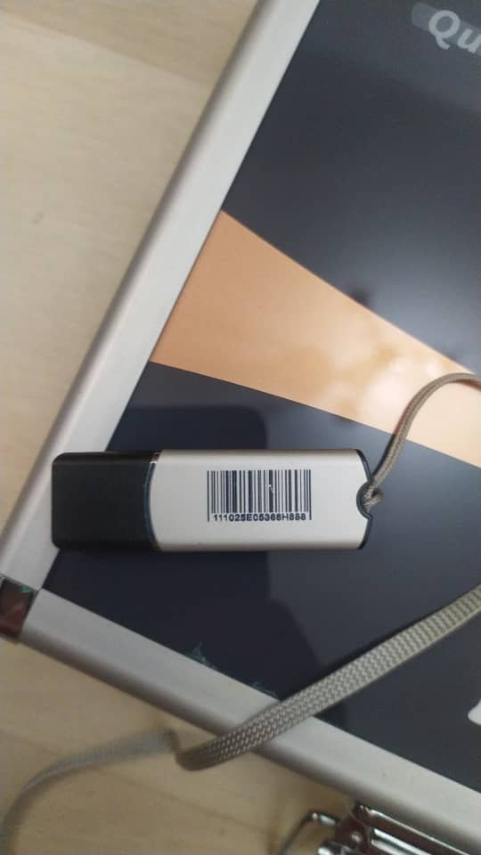 Person holding quantum resonance magnetic analyzer sensor during health scan